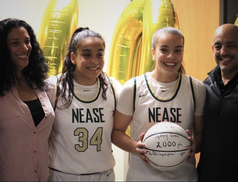 Sydney Gomes shares her accomplishment of 2,000 career points with her family.